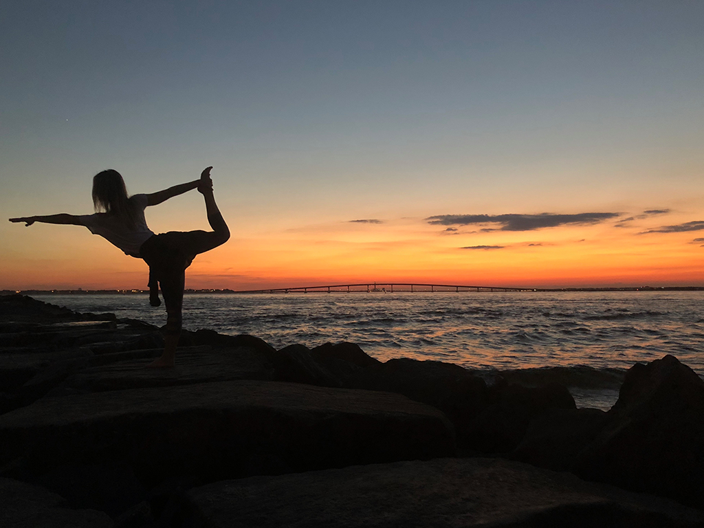 Woman posing at sunset for BlueHost Yoga